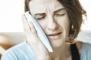 https://pixabay.com/photos/girl-ice-pack-toothache-dental-5661741/ Woman holding an ice pack on her cheek
