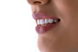 https://unsplash.com/photos/a-close-up-of-a-womans-mouth-with-white-teeth-RCQnbyQsnUg / Woman Smiling